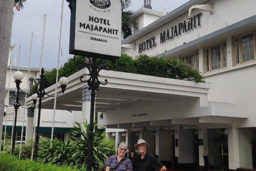 Hotel Majapahit with a sign, a covered entrance, and a building facade. 3