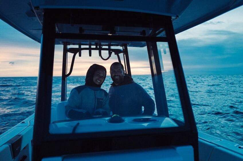 Two people on a boat with a view of the ocean. 2