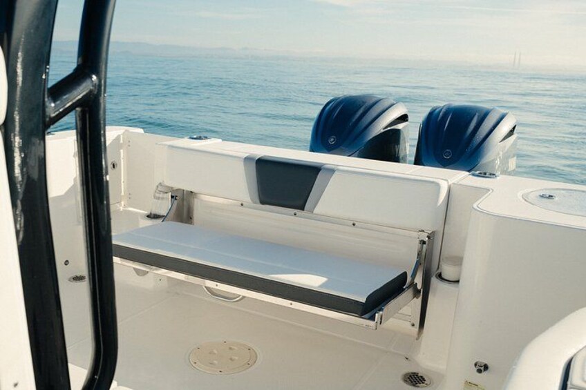 A boat's interior with a seating area and a hatch. 4