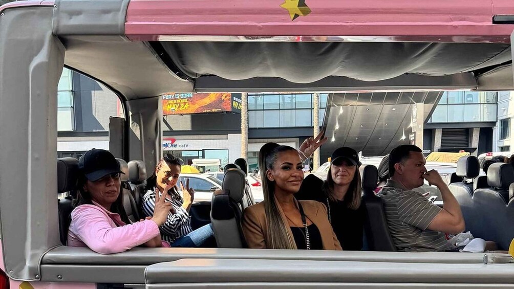 Passengers in a vehicle with a visible advertisement for 'Fury is Born' and a date 'May 24'. 1