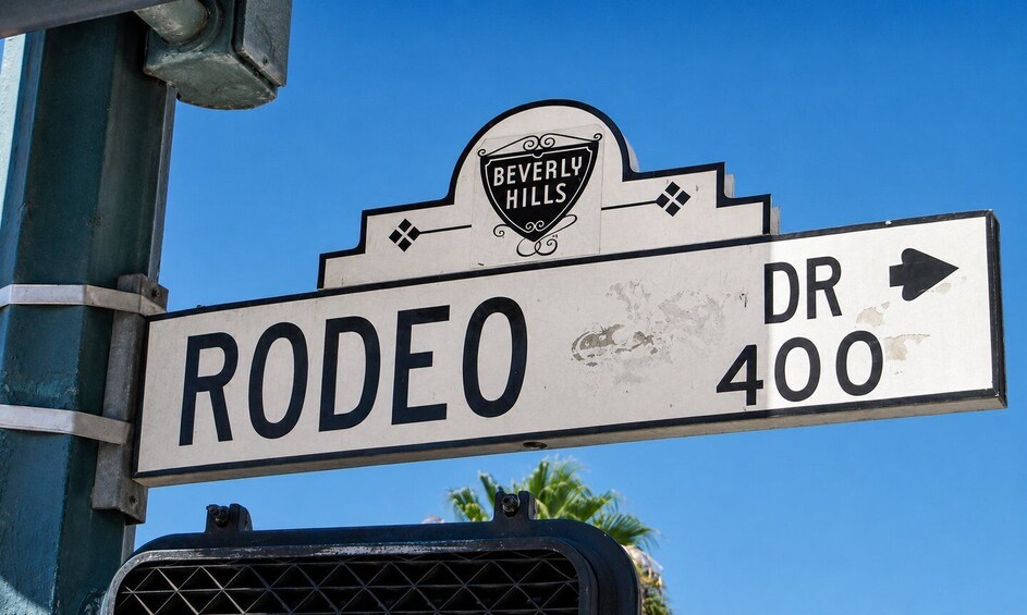 A street sign for Rodeo Drive, Beverly Hills, with an arrow pointing right and the distance marker 'DR 400'. 5
