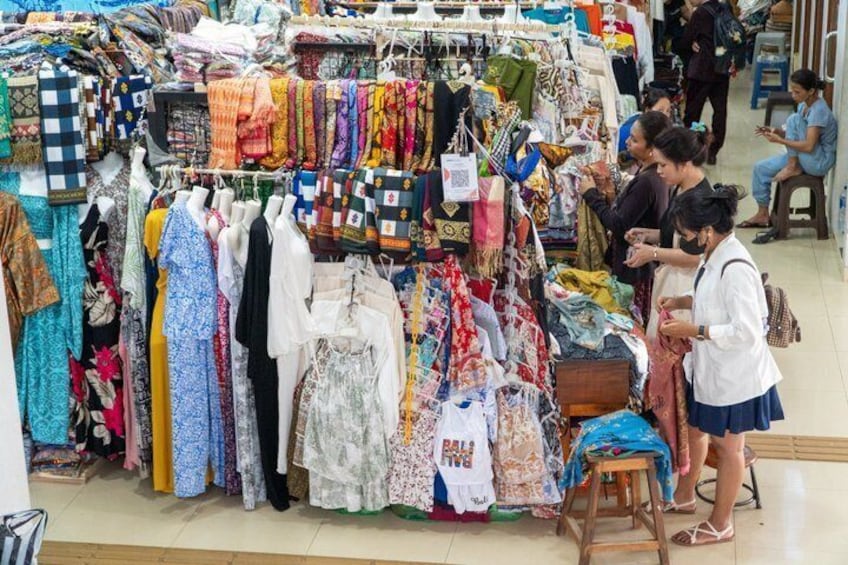 A clothing store with various garments on display. 4