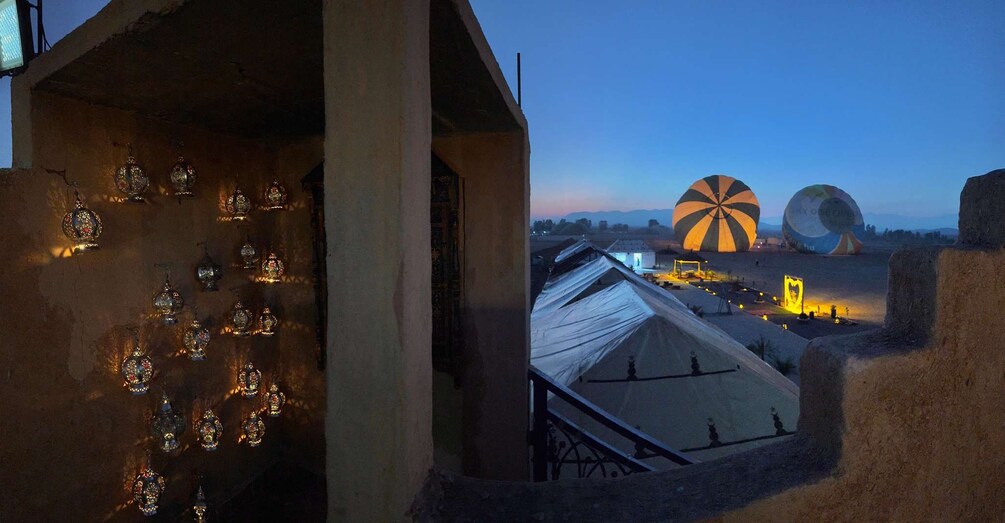 A building with ornate decorations and a view of large spherical structures in the distance. 5
