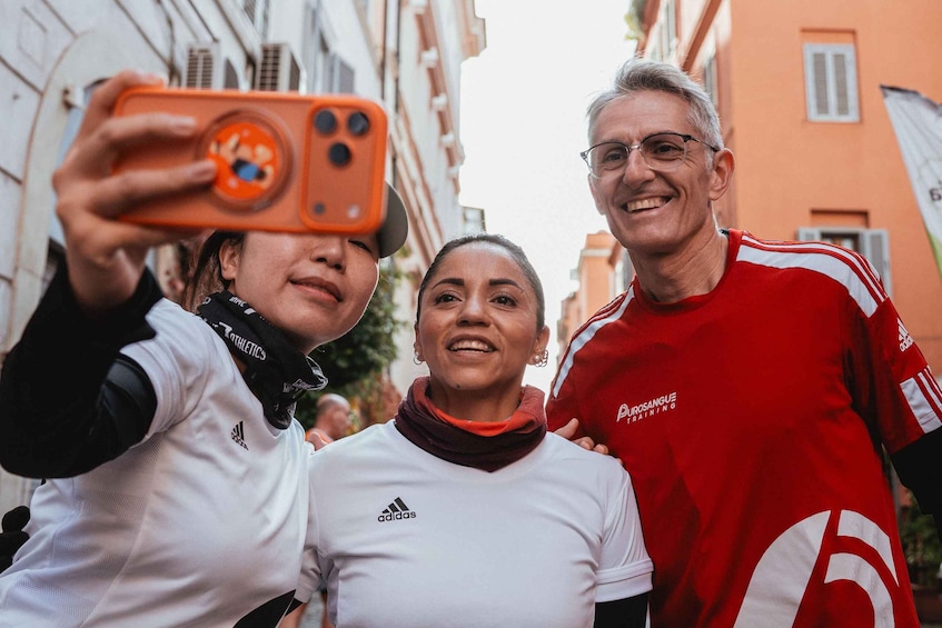 Three people taking a selfie with a smartphone. 3