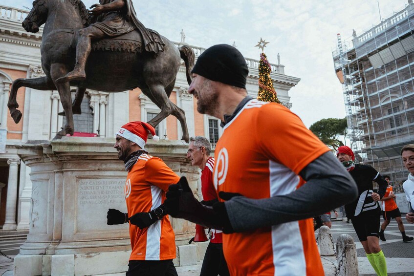 A group of people running in front of a historical monument with a statue of a horse and rider. 2