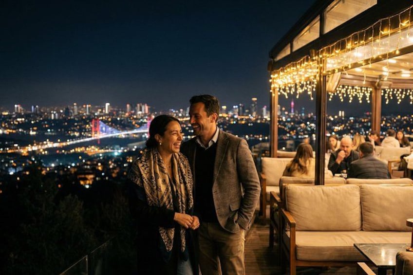 A couple standing on a rooftop overlooking a cityscape at night. 5