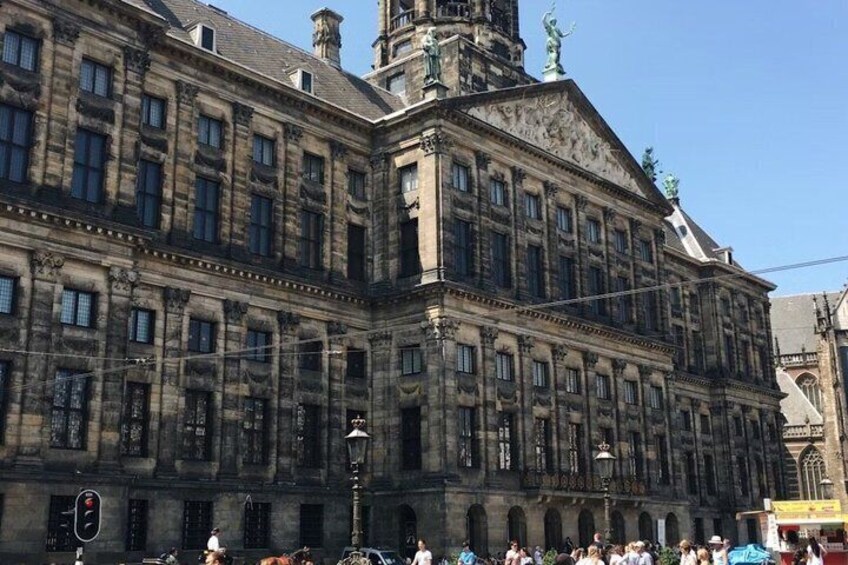 A historic building with classical architecture, featuring a prominent central tower and arched windows. 5