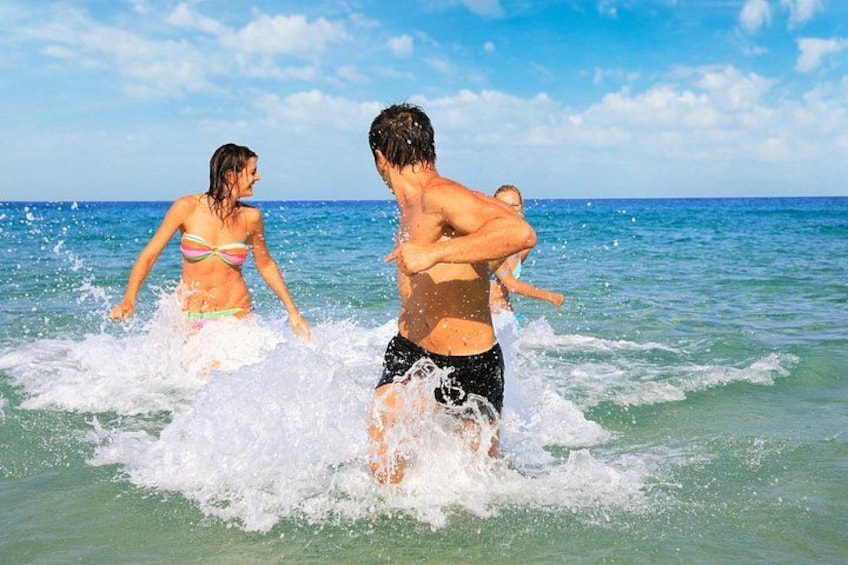 People playing in the ocean water. 1