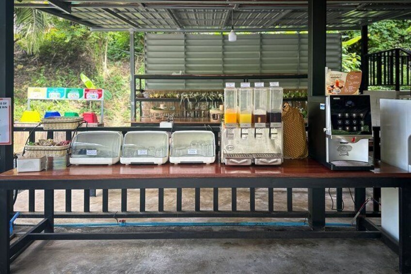 A coffee shop with a counter, coffee machines, and a menu board. 4