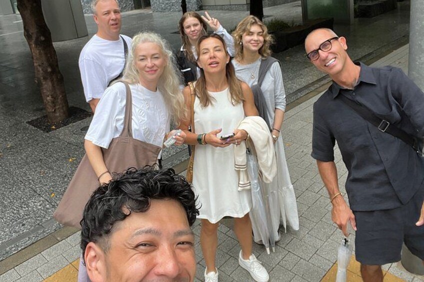 A group of people walking on a sidewalk. 2