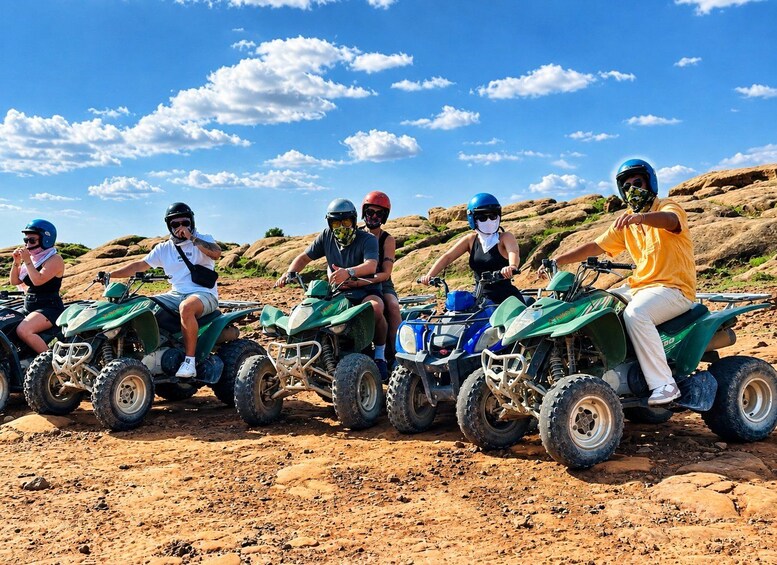 A group of people on ATVs in a rocky outdoor setting. 4