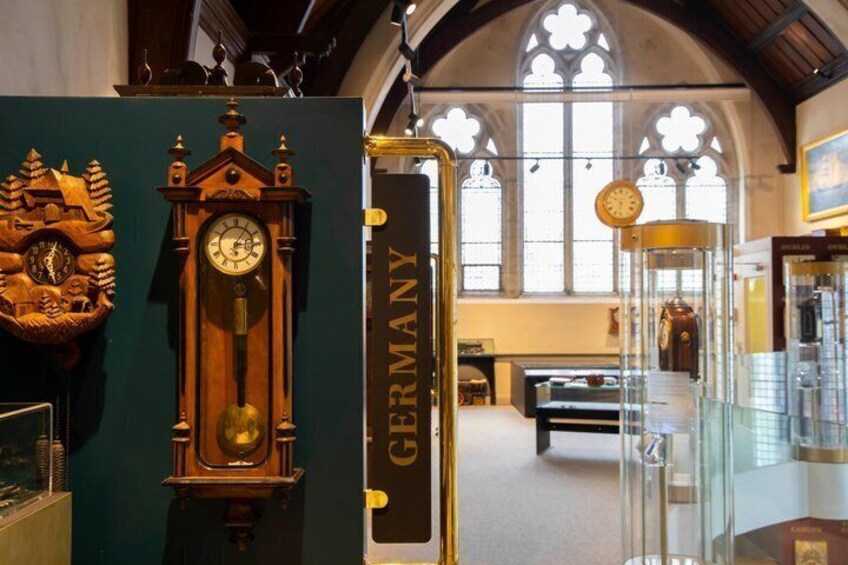 A clock, a display case, and a sign with the word 'GERMANY' in a museum. 3
