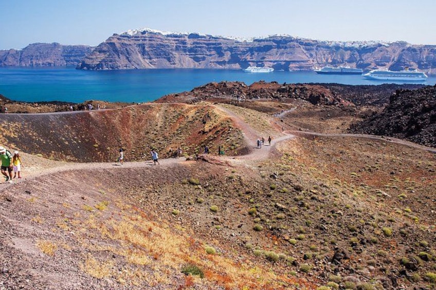 A coastal landscape with a dirt path, rocky terrain, and a distant view of the sea. 5