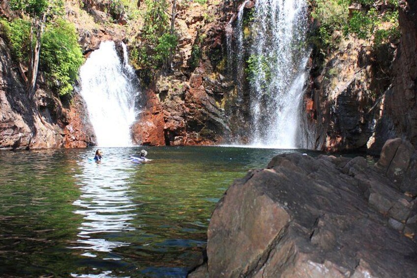 A waterfall, clear water, and rocky terrain. 3