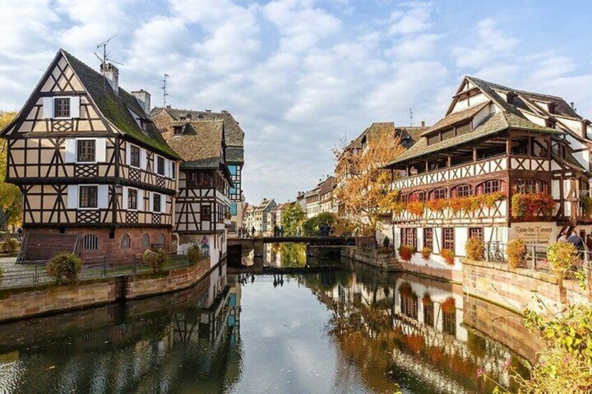 A canal with traditional half-timbered houses on either side. 3
