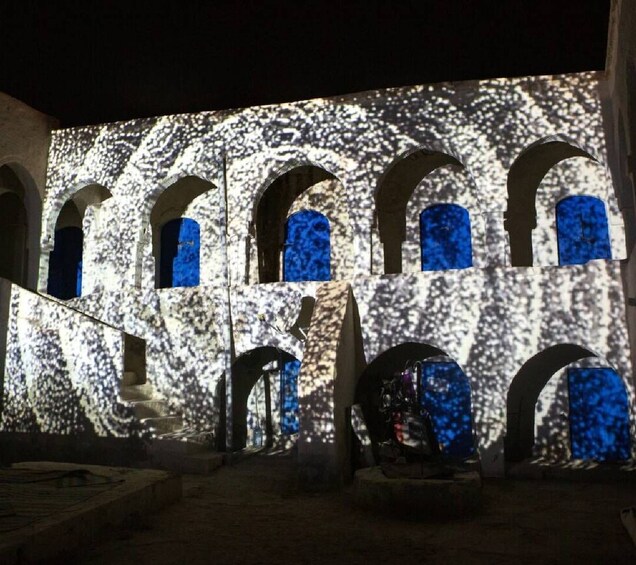 A building facade with arched windows and a textured wall. 2