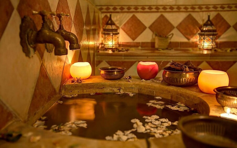 A traditional water feature with a fountain, candles, and decorative lanterns. 5
