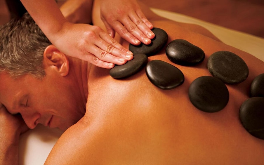 A person receiving a stone massage. 1