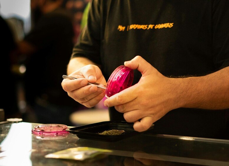 A person opening a pink container with a spoon. 3