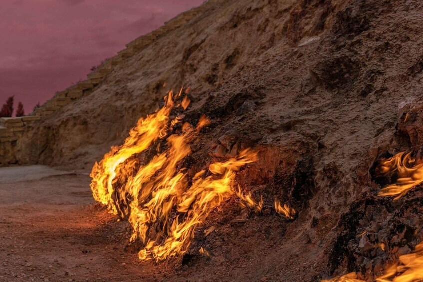 A fire burning on a rocky surface. 5