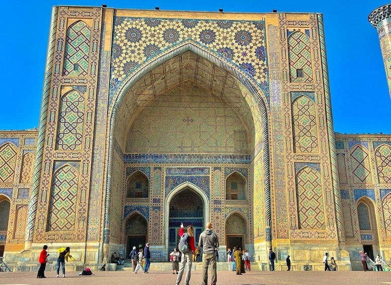 A historic building with intricate tile work and arched doorways. 3