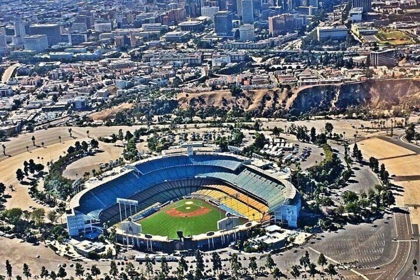 A large stadium surrounded by a cityscape. 2