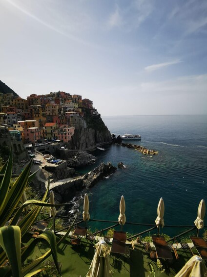 A coastal town with colorful buildings, rocky cliffs, and a clear view of the sea. 3