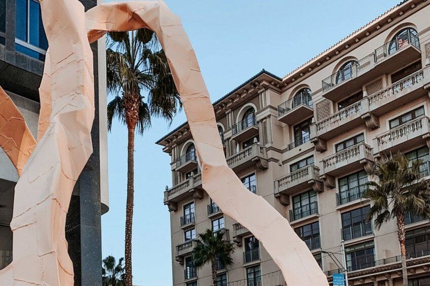 A building with balconies and palm trees. 4