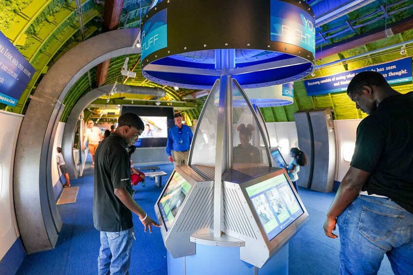 An indoor exhibit with interactive displays and a circular structure labeled 'YOU RIGHT STUFF'. 3