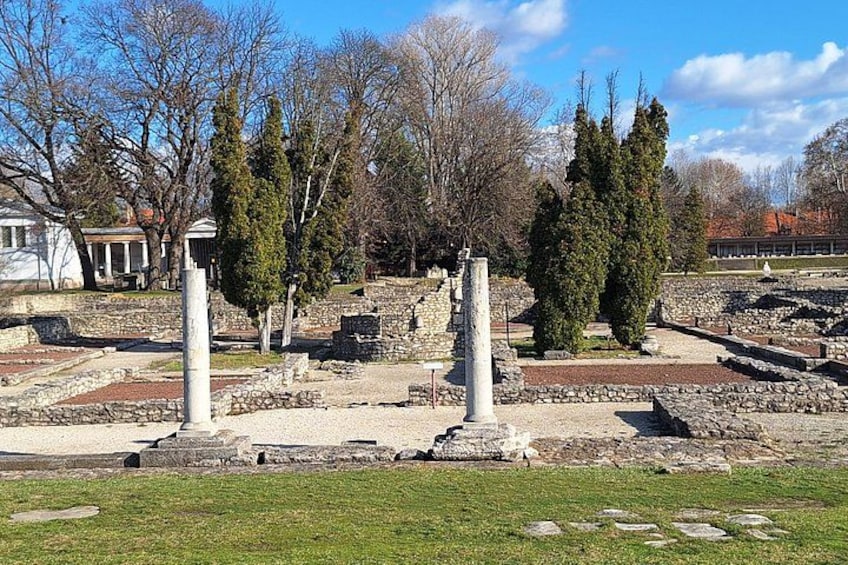 Ancient ruins with columns and stone structures. 4