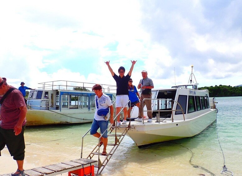 People boarding a boat at a dock. 3
