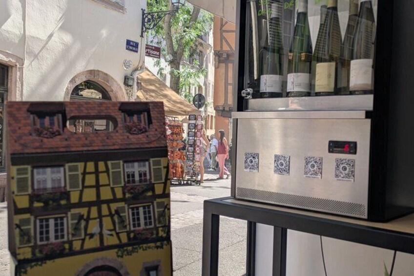 A street scene with a building facade, a wine cooler, and a street vendor. 3
