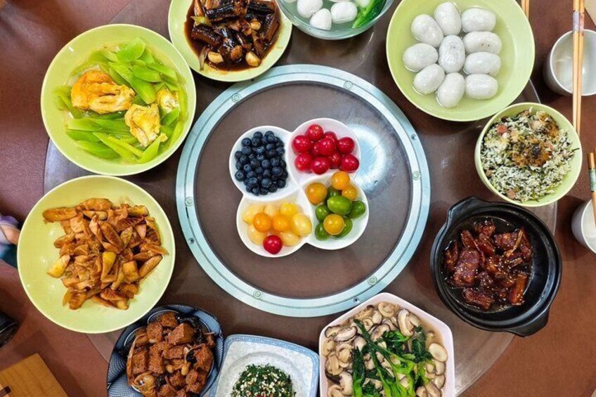 A variety of dishes including dumplings, meat, and vegetables arranged on a table. 1