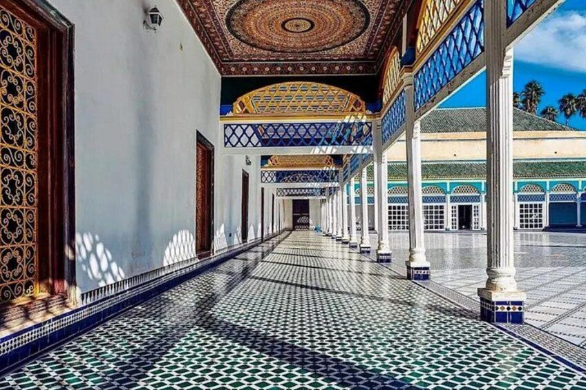A corridor with patterned tiles, ornate doors, and a tiled ceiling. 3
