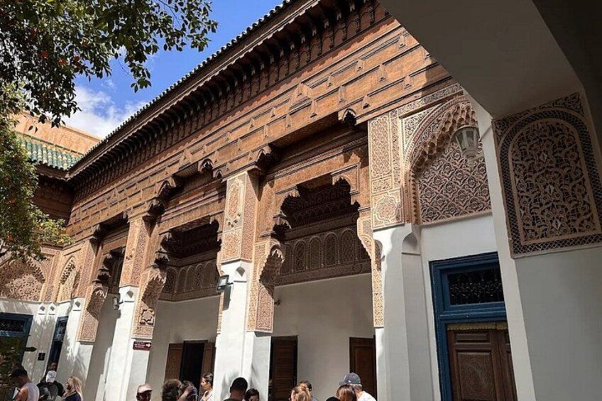 A courtyard with ornate arches and detailed tile work. 5