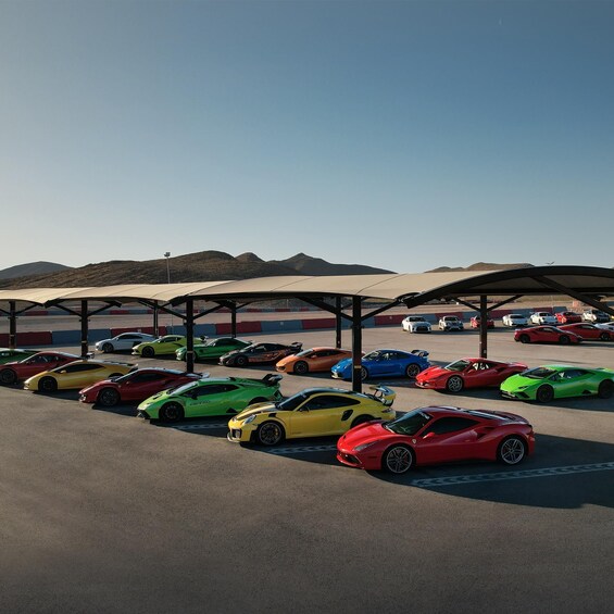 A parking area with multiple sports cars under canopies. 5
