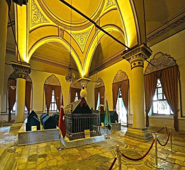 An ornate interior with high ceilings, columns, and chandeliers. 1