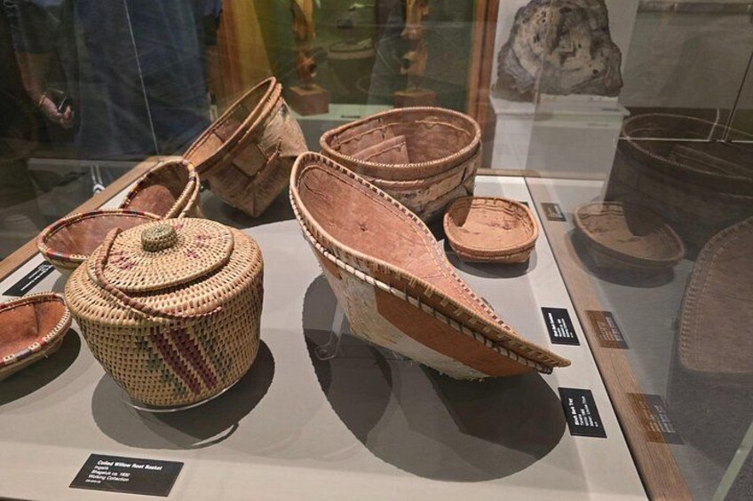 A display of traditional woven baskets and pottery. 2