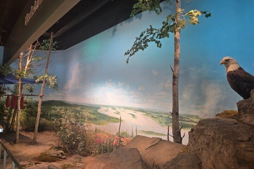 A large mural of a landscape with a bald eagle perched on a rock. 4