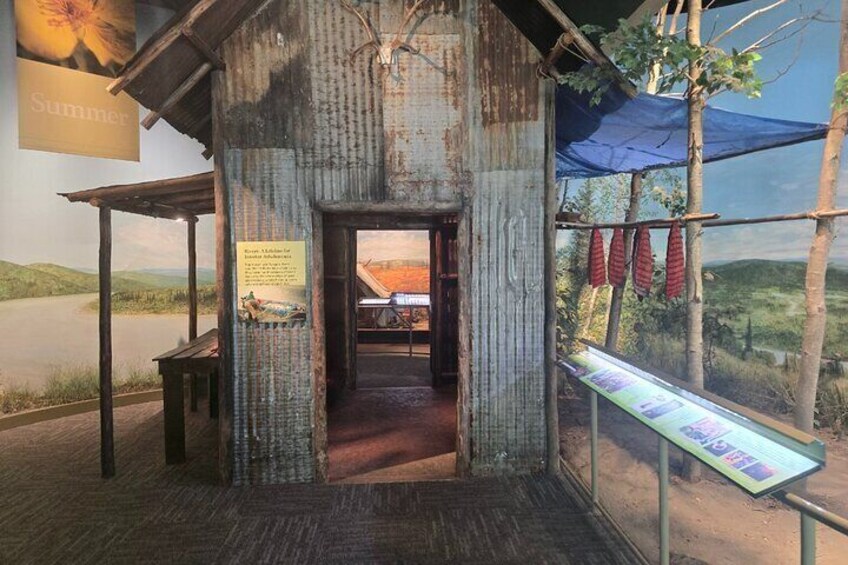 A rustic wooden structure with a view of a river and hills. 3