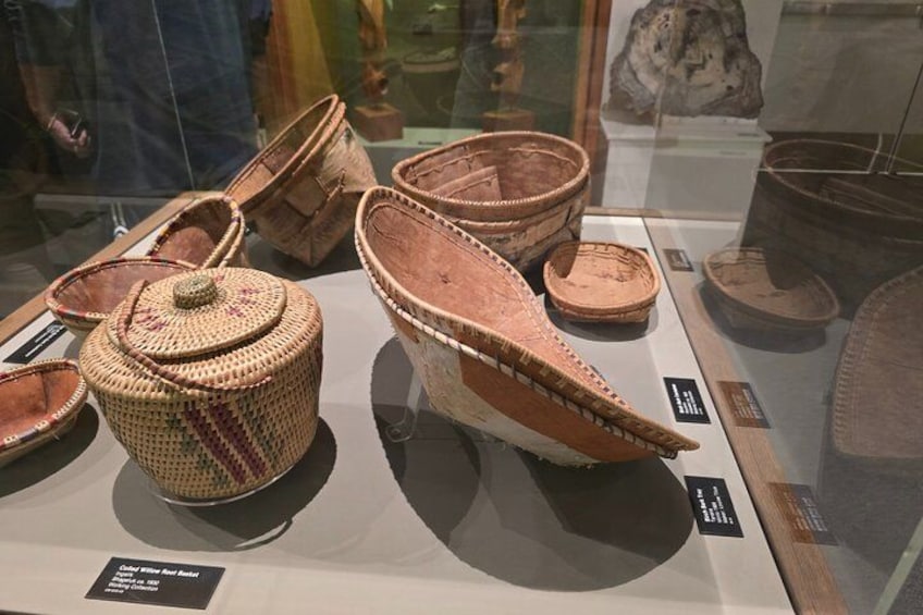 A display of ancient woven baskets and pottery. 3