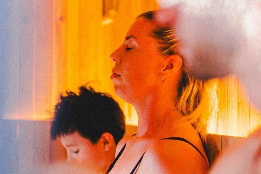 A person with a blurred face, wearing a black top, and a child in the foreground. 1
