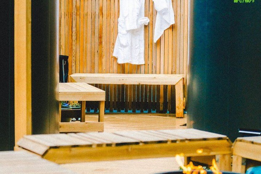 A wooden sauna with benches and towels. 2