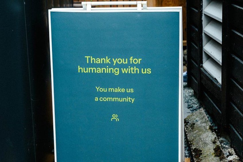 A teal sign with yellow text expressing gratitude for community support. 4