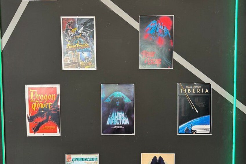 A wall with six posters, including 'Dragon Power' and 'Space Station Tiberia'. 4