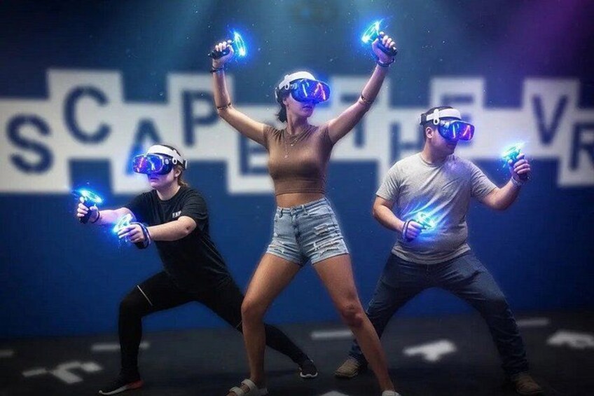 Three people wearing VR headsets and holding glowing objects. 1