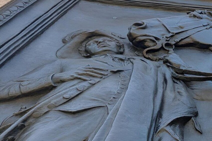 A detailed sculpture of a person in a historical costume. 3