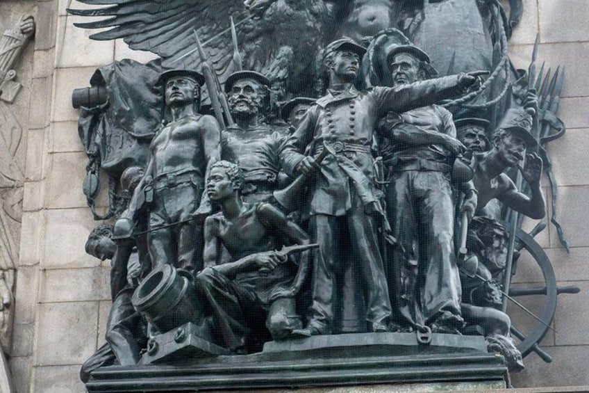A detailed bronze statue of soldiers on horseback, with one soldier pointing forward. 4