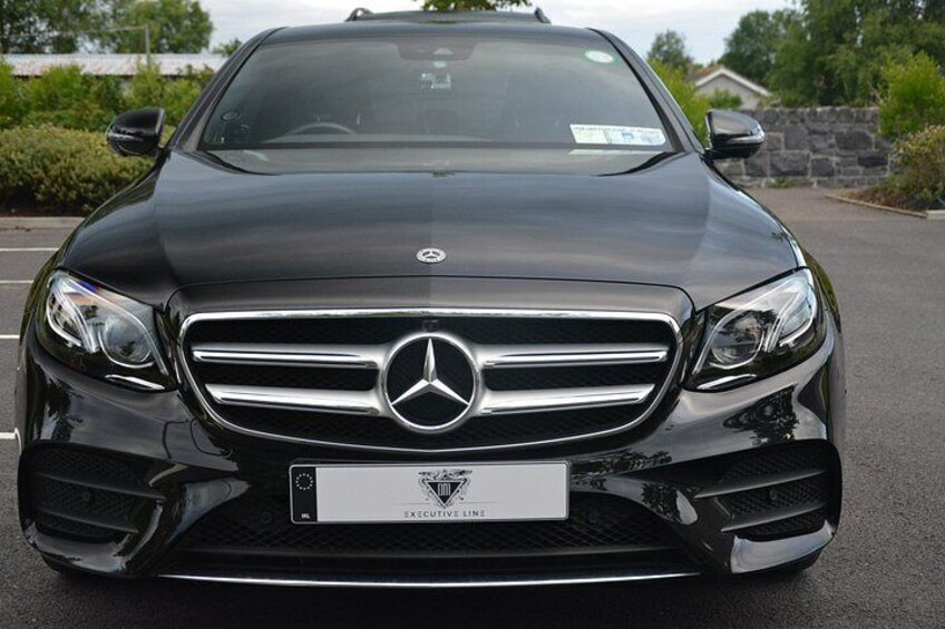 A black Mercedes-Benz with a visible license plate. 3