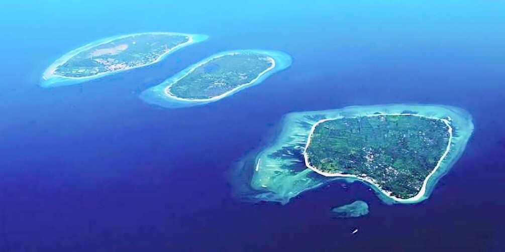 Three small islands surrounded by clear blue waters. 1